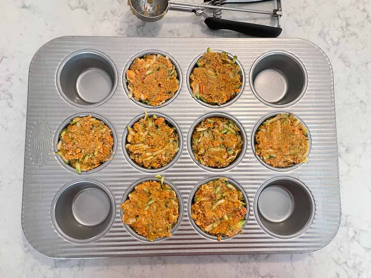 salmon cakes mixture divided into muffin cups