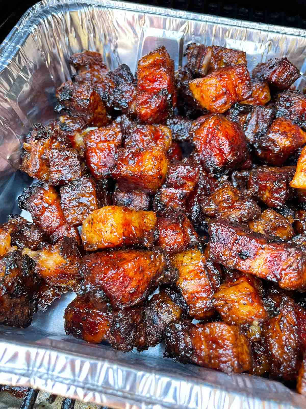 smoked pork belly burnt ends in aluminum pan