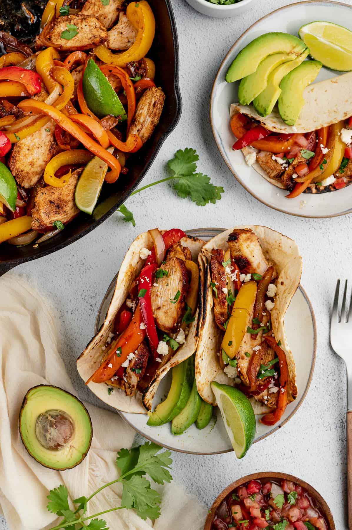 chicken fajitas assembled on a plate with fixings