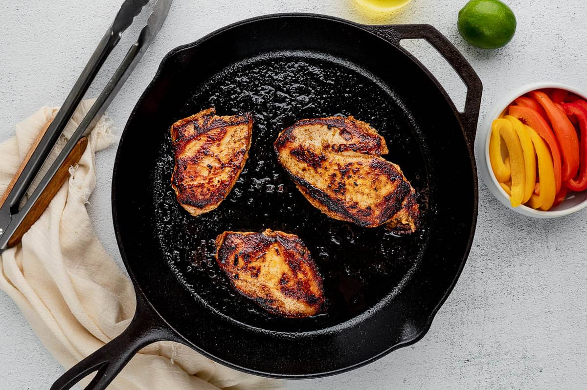 chicken breasts seared in cast iron skillet