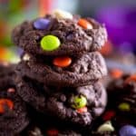 stack of chocolate halloween cookies with colorful candies