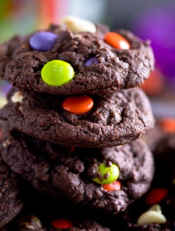 stack of chocolate halloween cookies with colorful candies