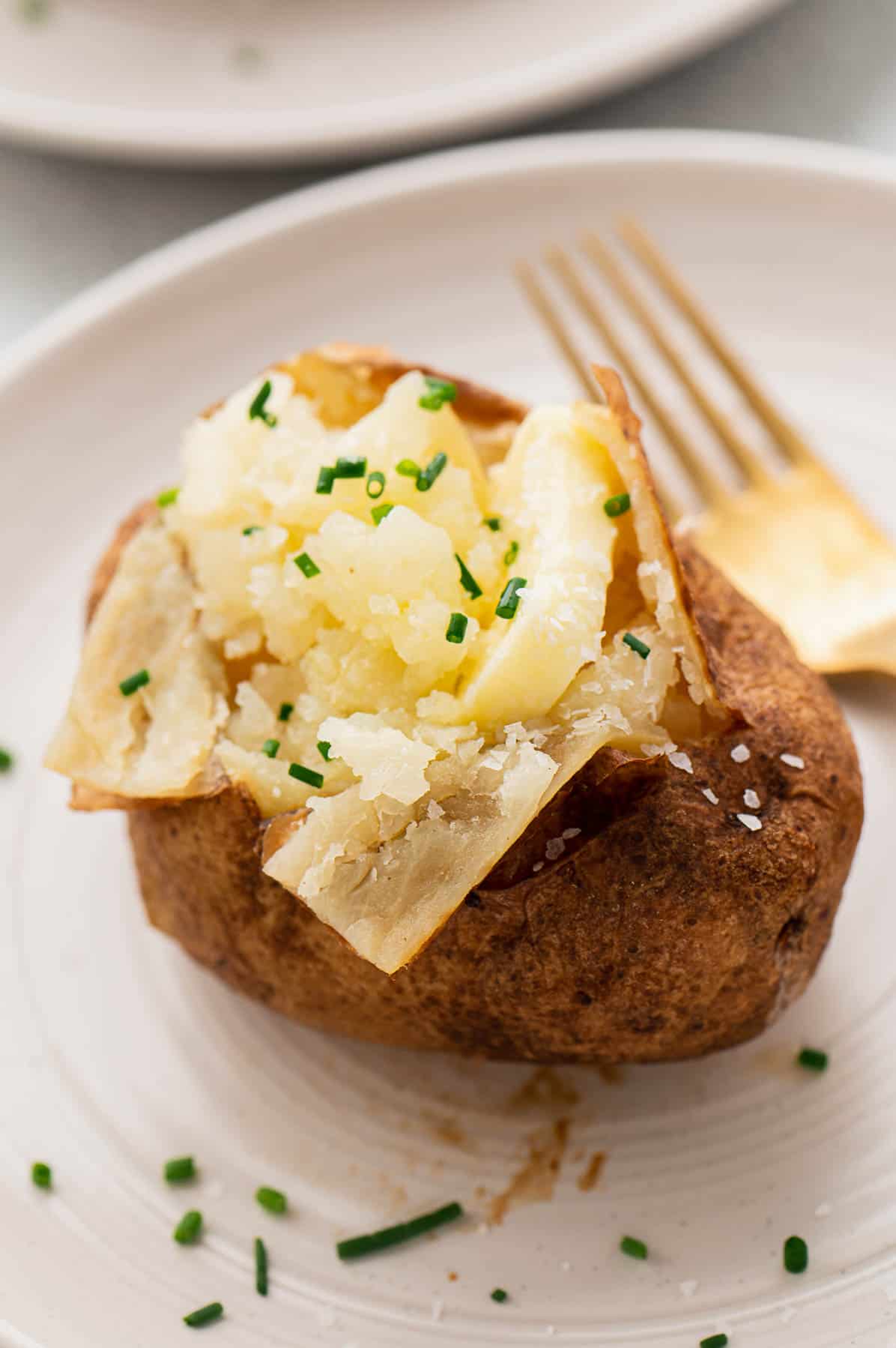 fluffy baked potato with butter and chives