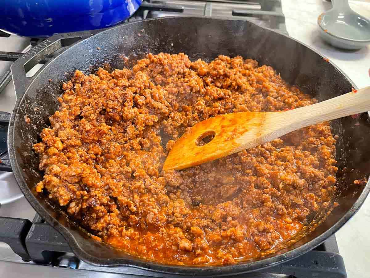 chili sauce cooking in cast iron skillet