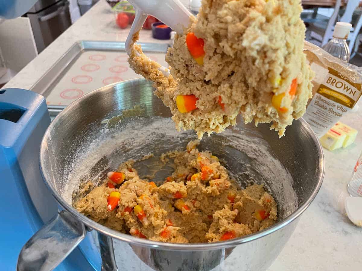 cookie dough with candy corn in mixing bowl