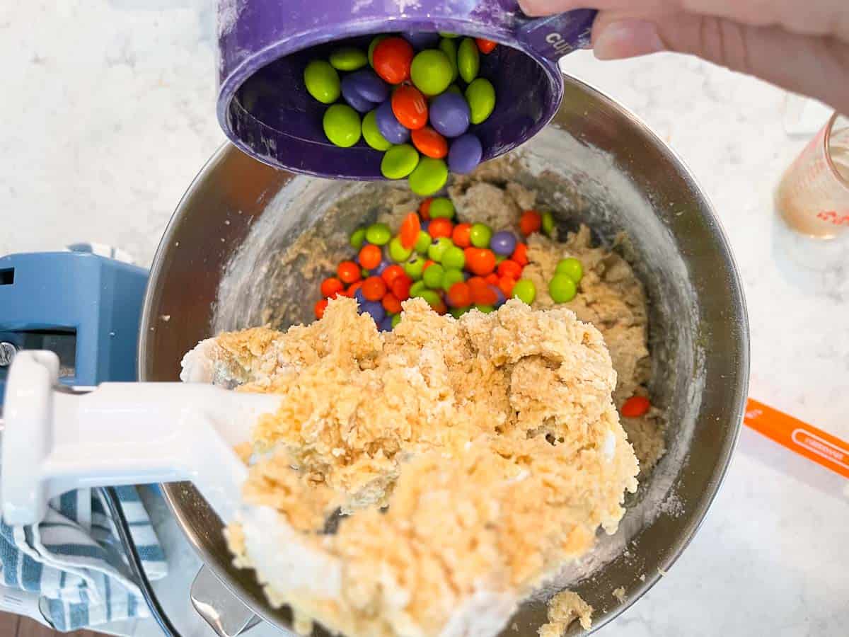 mixing ingredients in stand mixer for halloween cookie bars