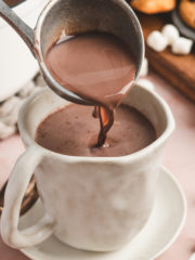 hot cocoa poured into mug with ladel