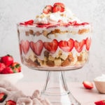 layers of strawberries and cake and cream in a trifle dish